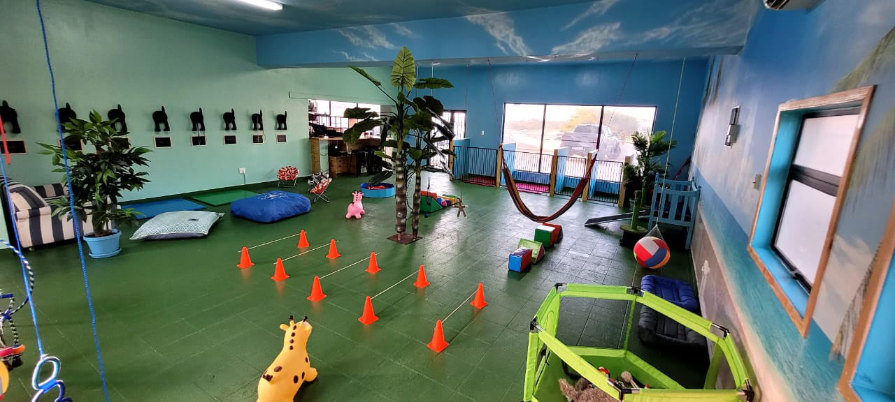 Play room with a tropical beach mural and hammock